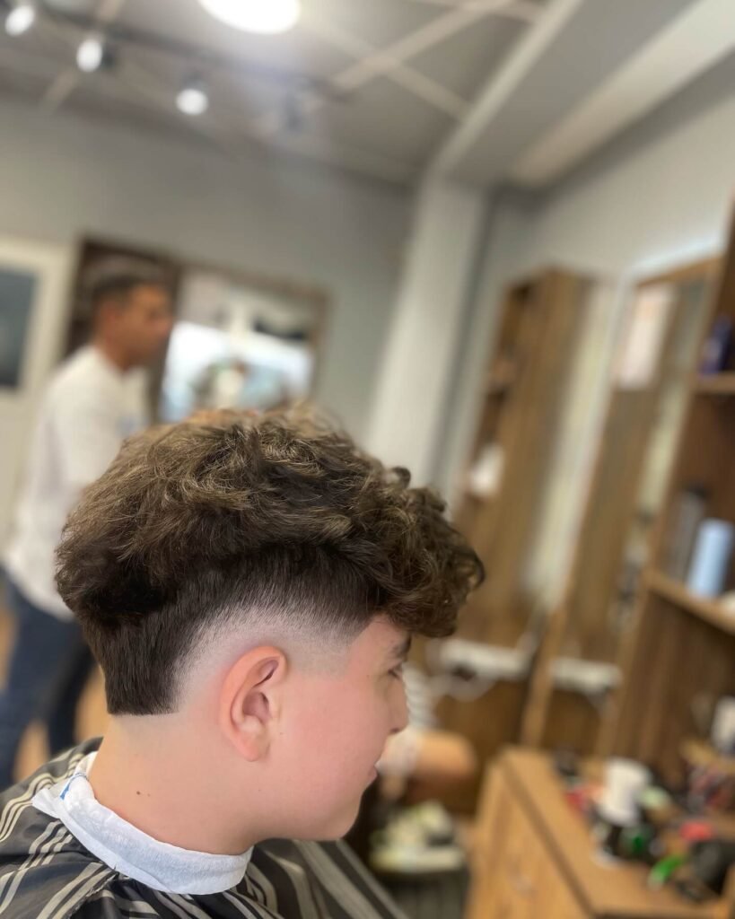 Burst Fade with Curly Top Haircut for men